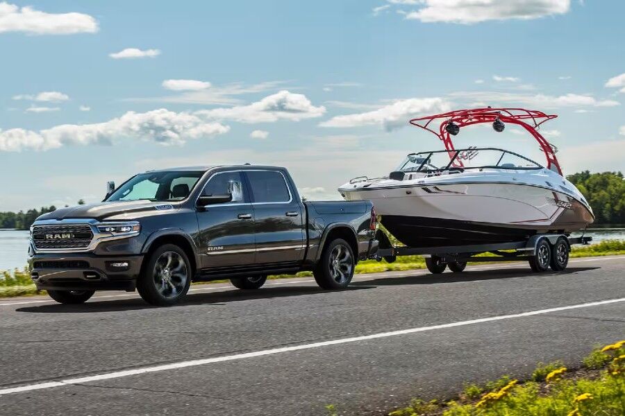 2024 RAM 1500 Exterior Driver Side Front Profile while Towing a Boat