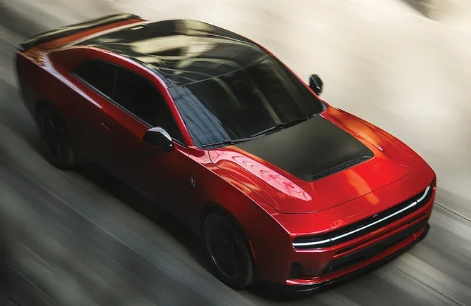 Red 2026 Dodge Charger seen from above at speed on an open road