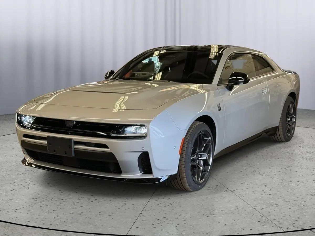 A dark blue Dodge Charger photographed from the front three-quarter on a showroom turntable.