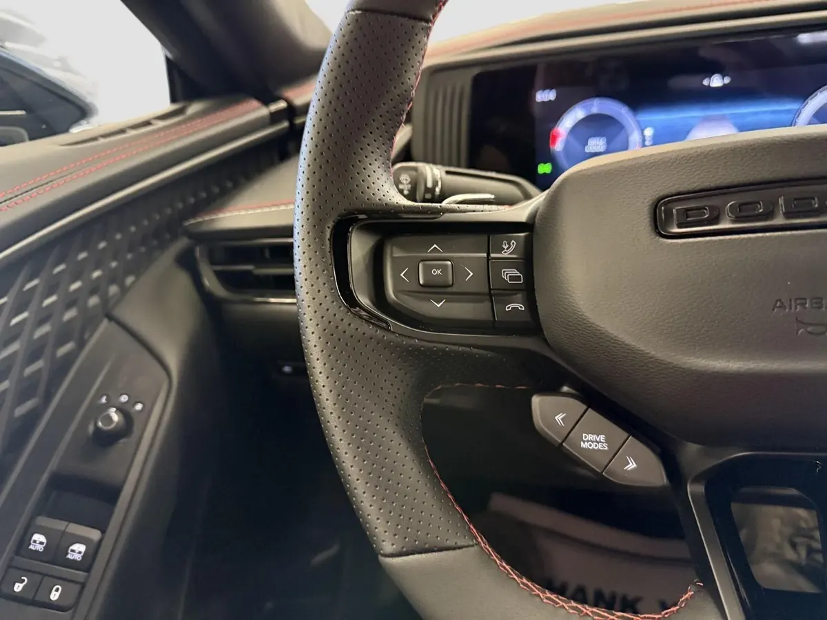 The steering wheel and instrument cluster from the driver's seat.