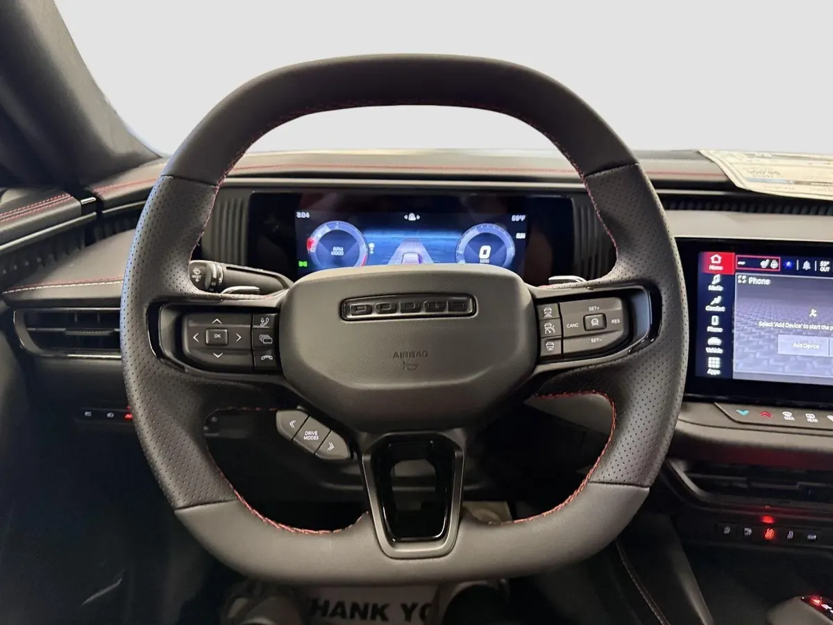 The steering wheel with the cluster visible through it.