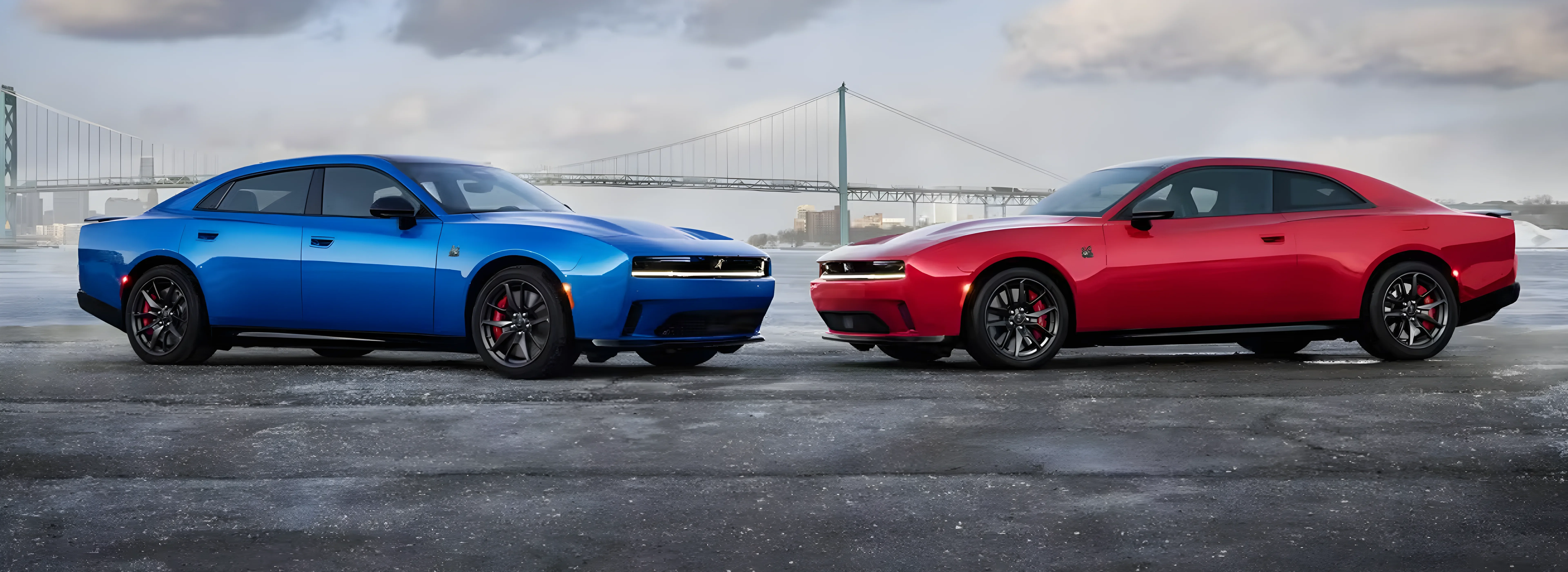 Blue and red 2026 Dodge Charger models parked nose-to-nose on a waterfront lot
