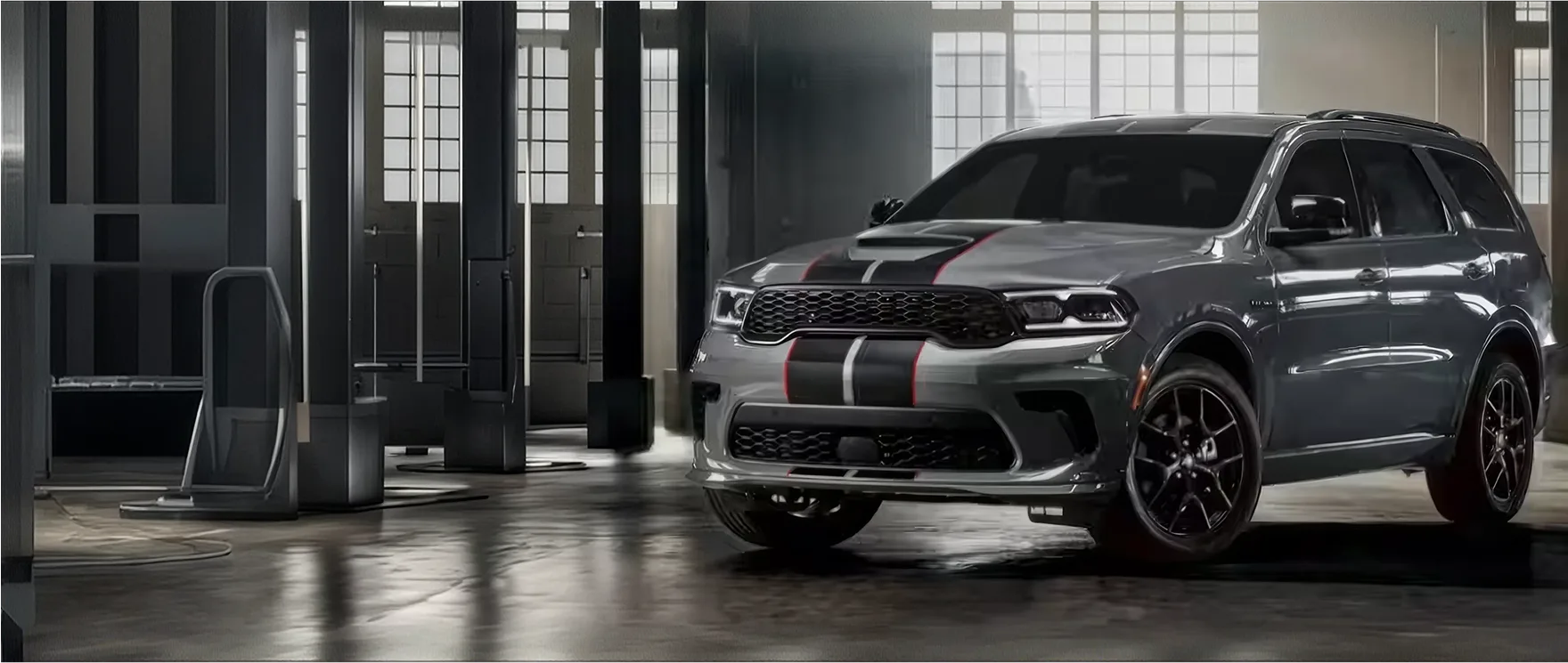 Dark Dodge Durango with silver stripes parked inside an industrial hall