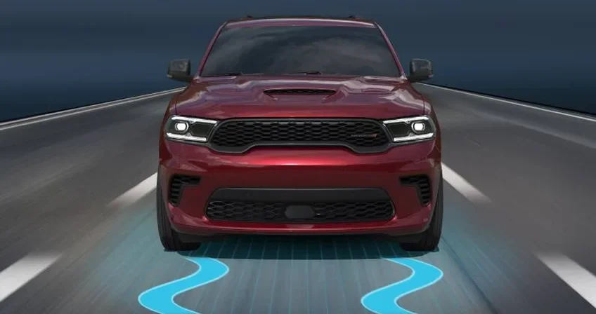 Red Dodge Durango head-on with blue traction graphics beneath its wheels