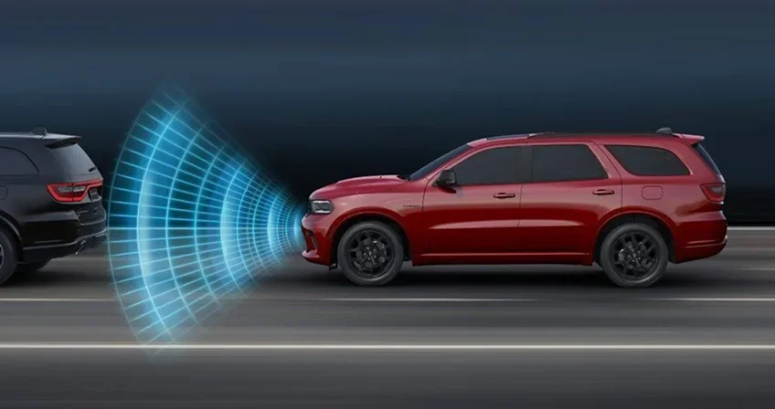 Red Dodge Durango with blue sensor waves projected ahead of it