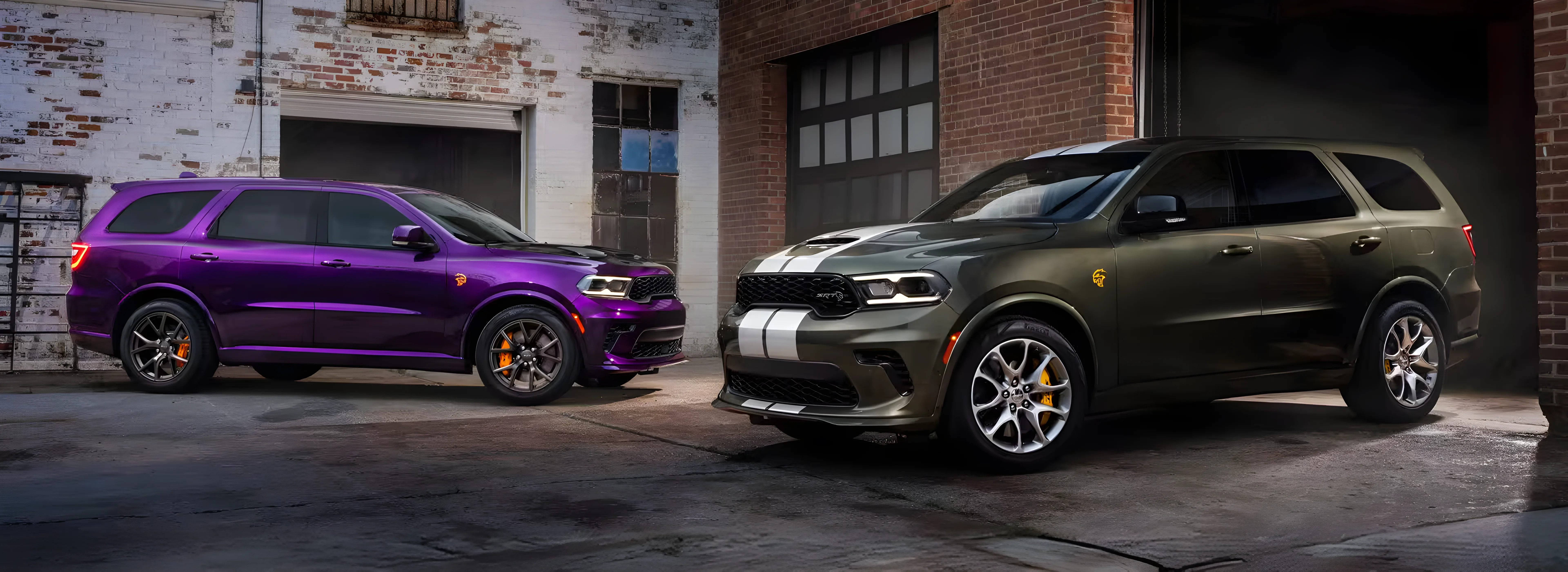 Purple and olive 2026 Dodge Durango models parked nose-to-nose in a dark garage