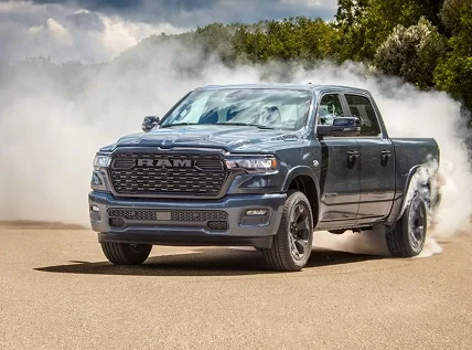 Blue RAM 1500 kicking up dust on a dirt trail