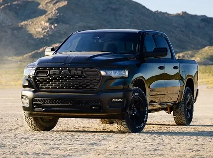 Blue RAM 1500 parked on a desert flat with mountains behind it