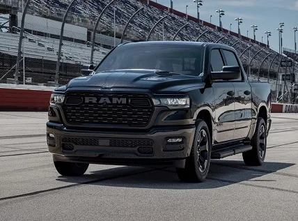 Black RAM 1500 parked on a race circuit, front three-quarter view