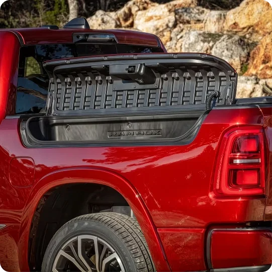Open RamBox side storage bin on the bed of a red RAM 1500