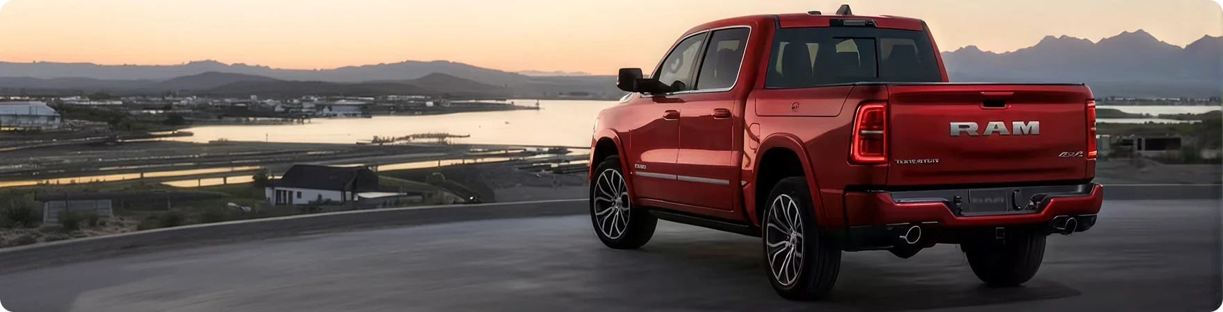 Red RAM 1500 seen from the rear three-quarter at dusk showing the R-A-M tailgate badging
