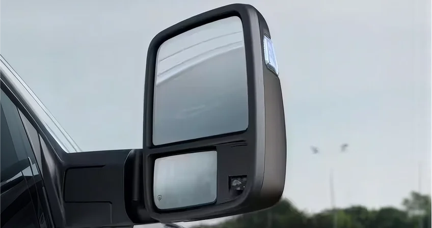 Close-up of an extended telescopic trailer tow mirror on a RAM 1500