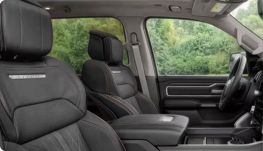 Front bucket seats and dashboard of the RAM 1500 Tungsten interior in black leather