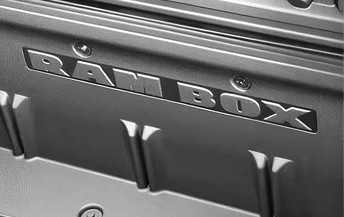 Close-up of the RAM BOX lettering embossed on the bed side of a RAM 2500