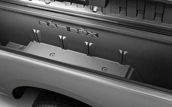 Silver RAM 2500 bed side showing the closed RamBox lid and RAM BOX badging