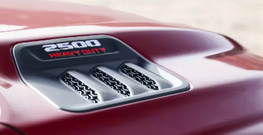 Close-up of the Mopar Sport Performance Hood scoop and 2500 Heavy Duty badge on a red RAM 2500