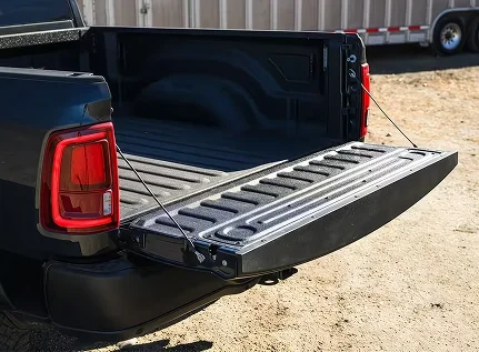 Lowered tailgate of a RAM 2500 with a loading ramp resting in the bed