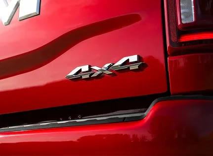 Chrome 4x4 badge on the rear bedside of a red RAM 2500