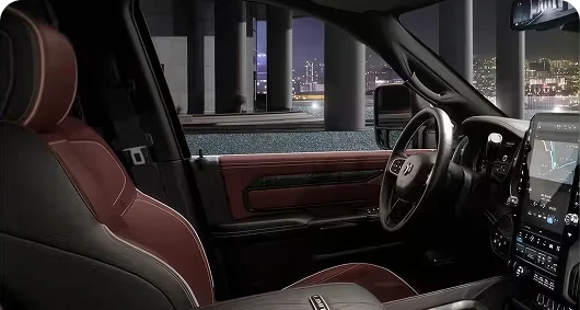 RAM 3500 Limited interior with black and burgundy leather seats and a wood-trimmed dashboard