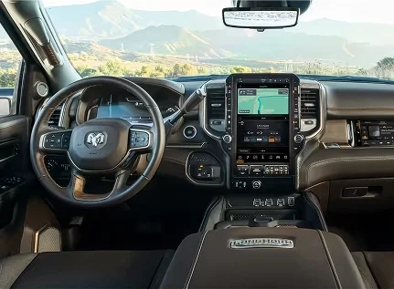 RAM 3500 Longhorn cockpit with the steering wheel, vertical touchscreen and mountain view through the windshield