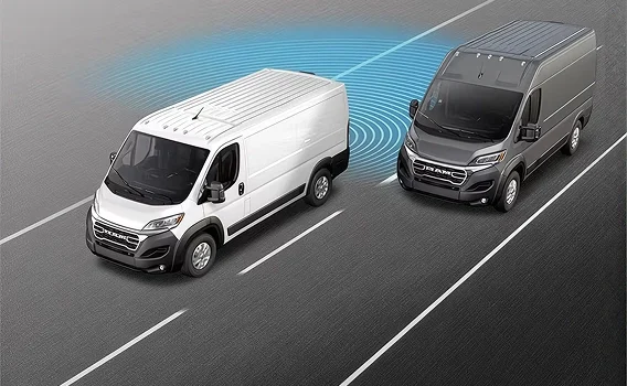 Aerial view of a white RAM ProMaster van with a blue blind-spot warning zone beside a nearby van