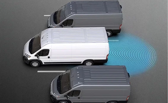Aerial view of a gray RAM ProMaster van parking between two other vans with blue sensor waves