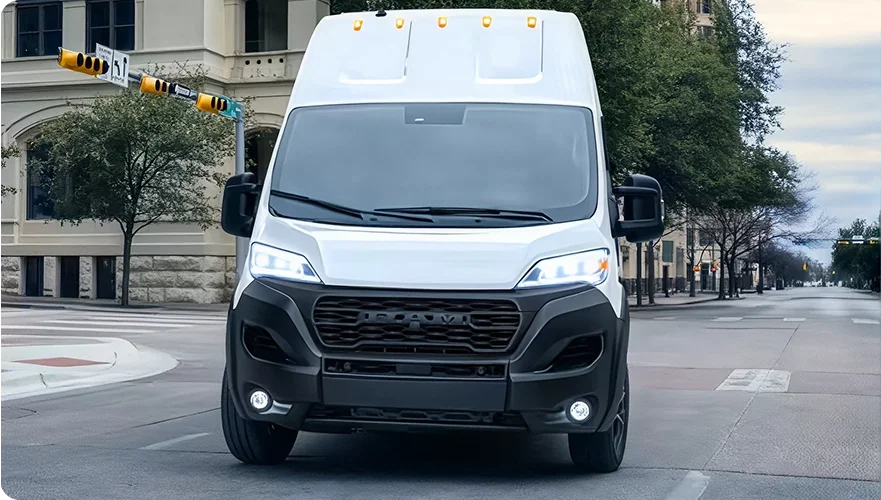 White RAM ProMaster super high roof van parked on a city street