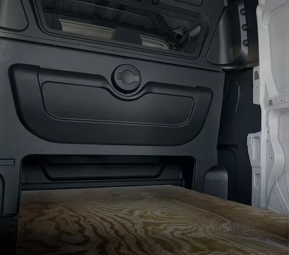 Open storage space beneath the folded rear seat of a RAM ProMaster crew van