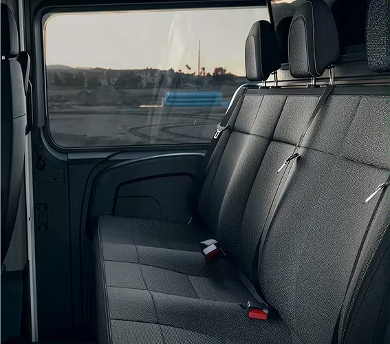 RAM ProMaster crew van rear seats with side windows and a view of the parking lot outside