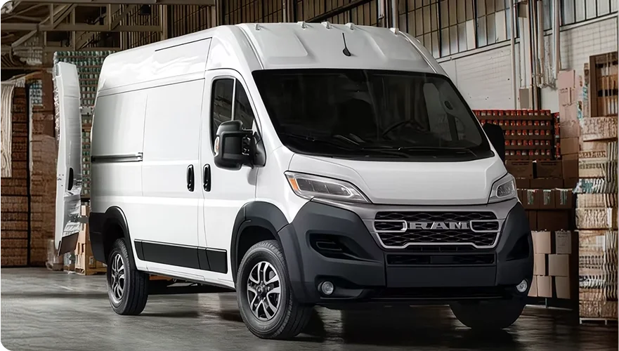 White RAM ProMaster cargo van parked in a warehouse loading area