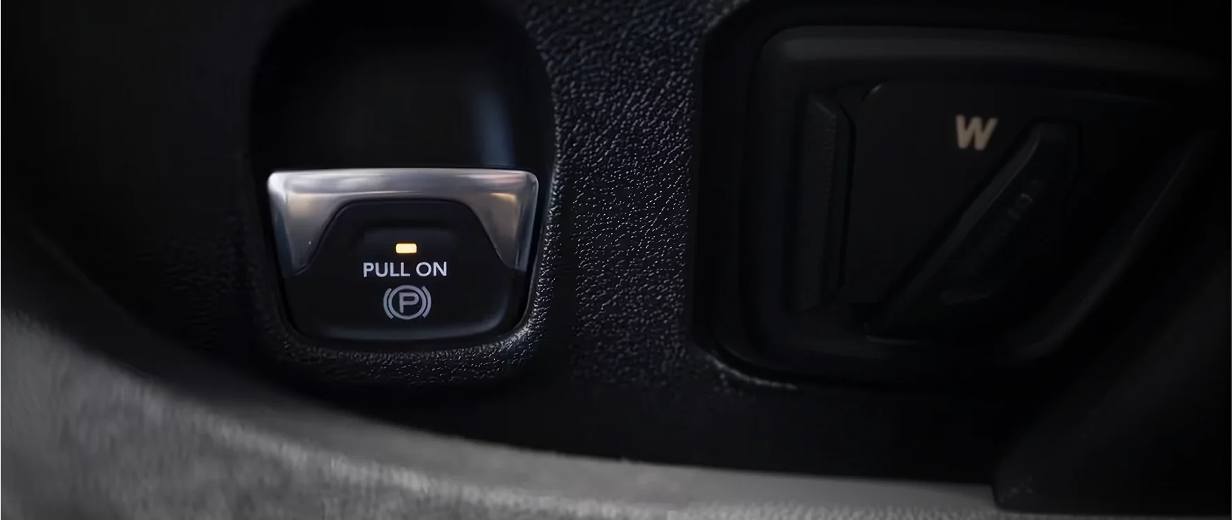 Close-up of the Pull On electronic parking brake switch on a RAM ProMaster dashboard