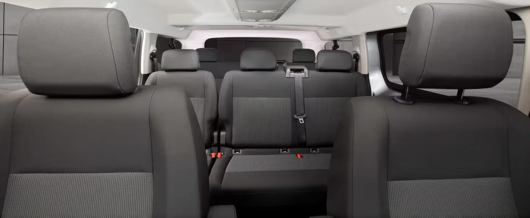View from the front seats of a RAM ProMaster City Passenger Van across the second- and third-row cloth bench seats