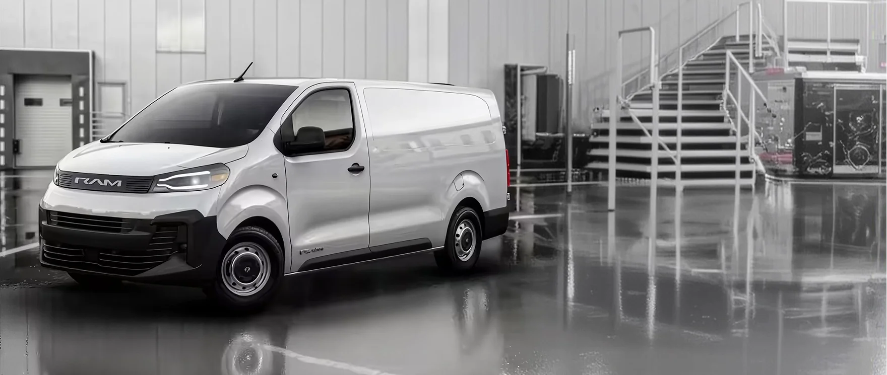 White RAM ProMaster City cargo van parked on a polished floor inside a bright industrial building