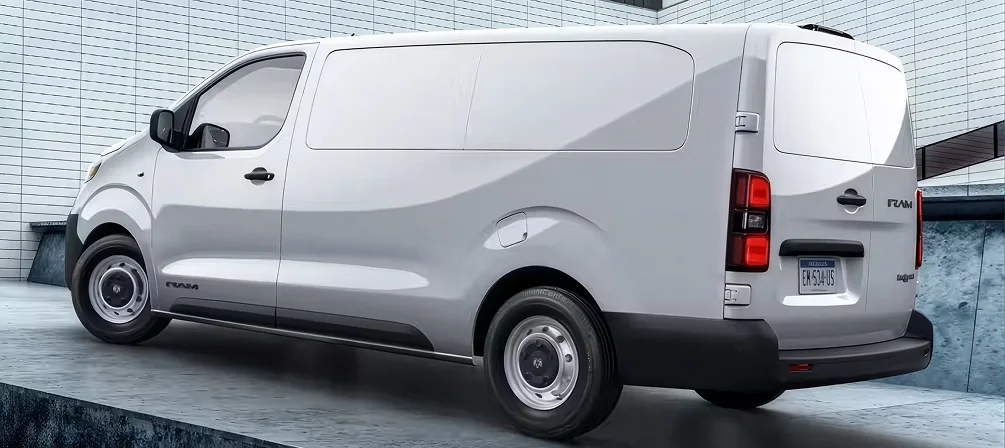 Rear three-quarter view of a white RAM ProMaster City cargo van parked beside a white tile wall