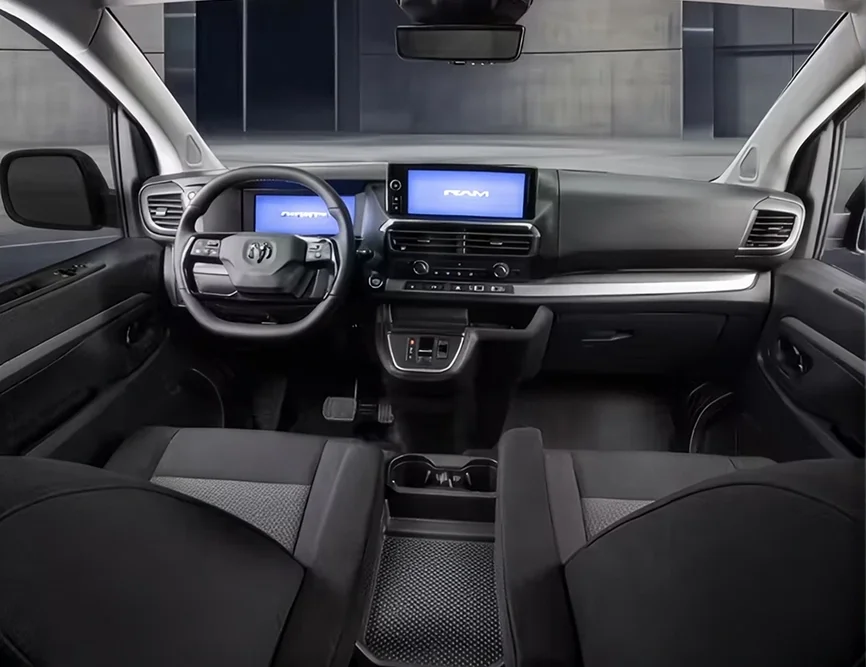 RAM ProMaster City front cabin with the steering wheel, digital cluster, center touchscreen and cloth bucket seats