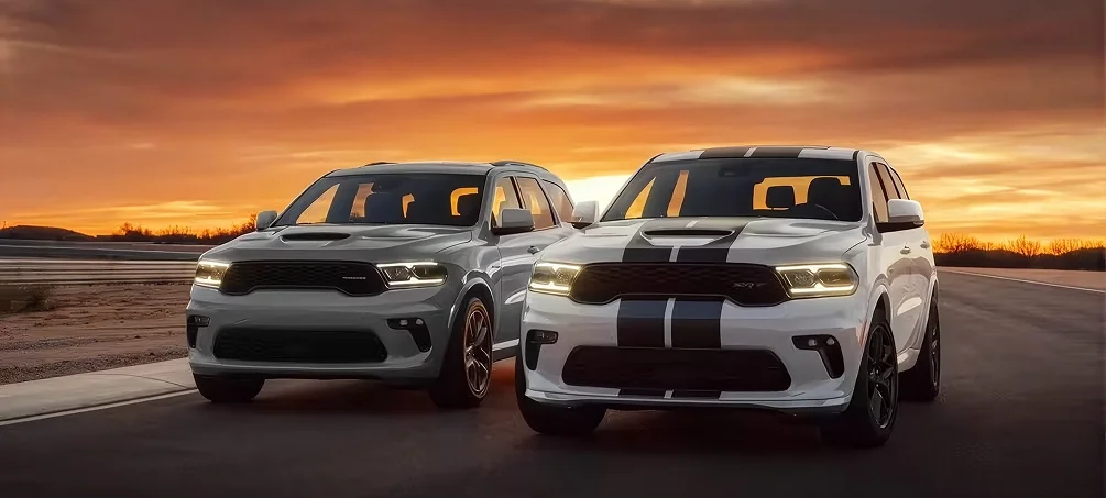 Dodge Charger parked outside a dealership at golden hour