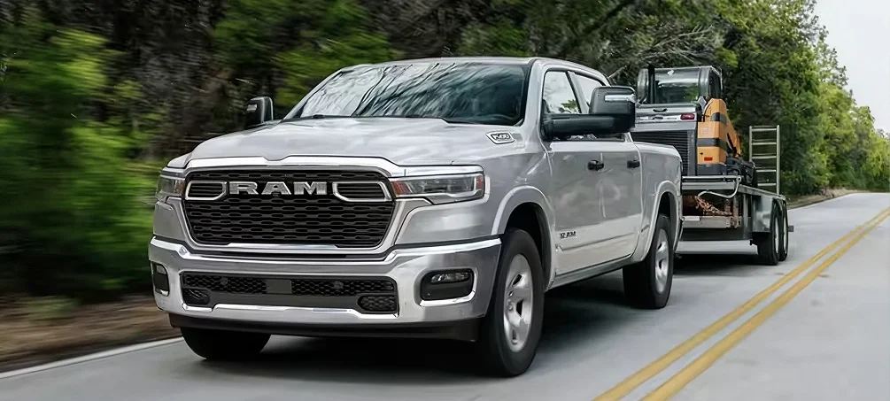 RAM 1500 parked in front of a dealership showroom