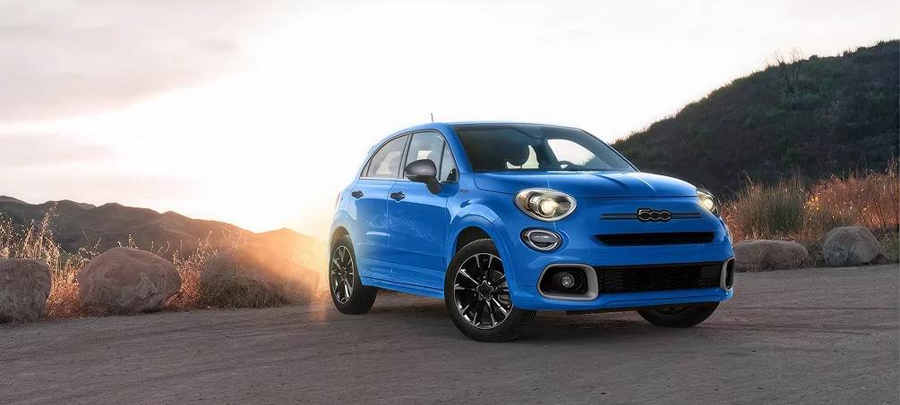Blue FIAT 500X parked on a gravel overlook at sunrise