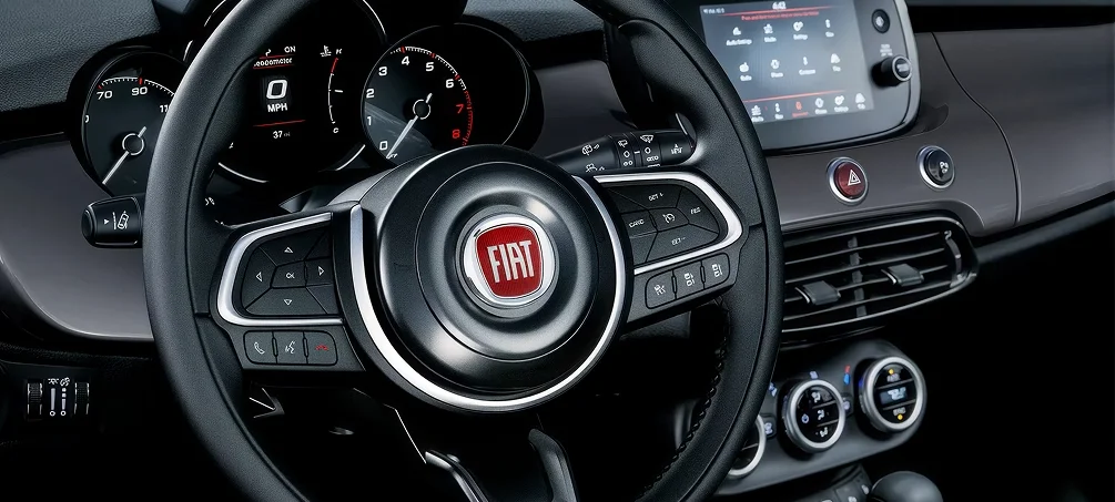 FIAT steering wheel, instrument cluster and touchscreen inside a certified pre-owned FIAT