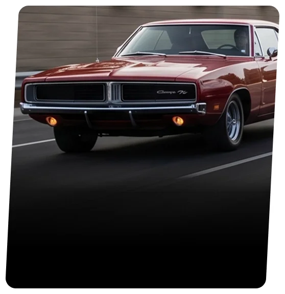 Silver Dodge Charger coupe travelling down a tree-lined highway